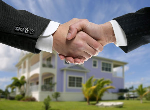 handshake in front of house